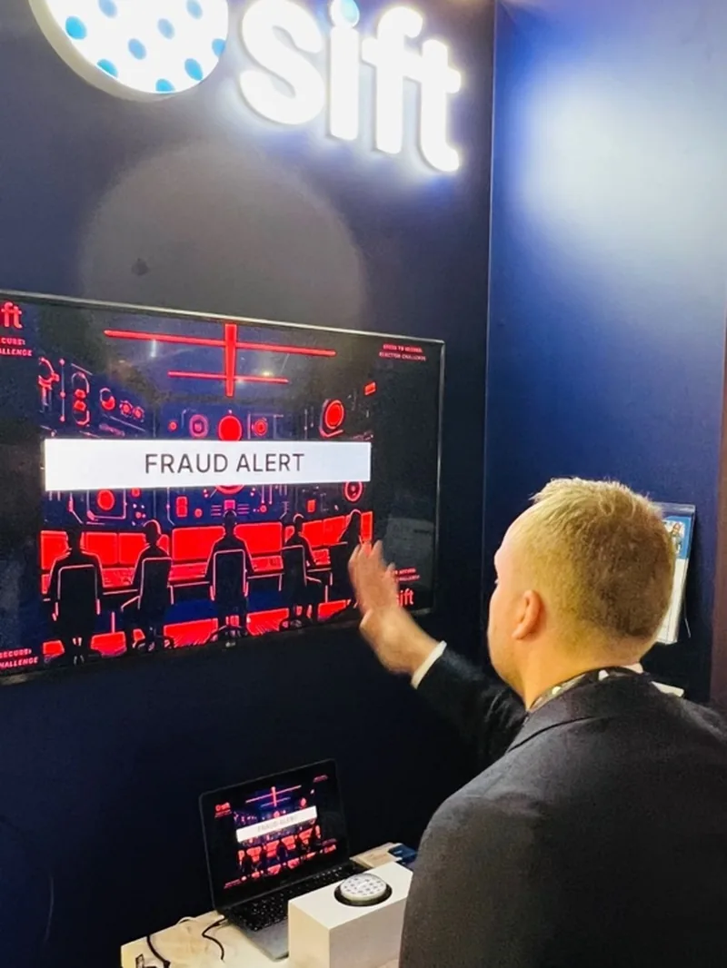 Attendee playing the custom Sift fraud alert response game on a booth screen.