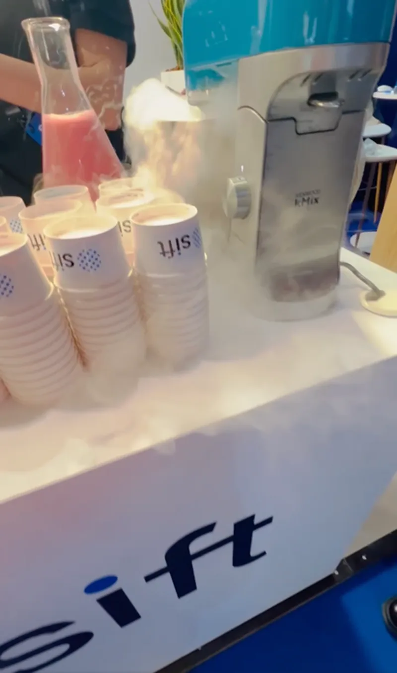 Liquid nitrogen ice cream being made at the Sift booth with smoke rising from branded cups.